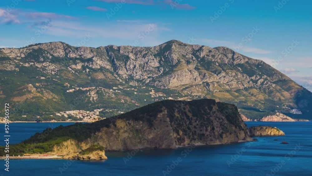 Island of St. Nicholas in the Adriatic Sea near the shores of the town of Budva in the rays of the sun Island of St. Nicholas in the Adriatic Sea near the shores of the town of Budva in the rays of the sun