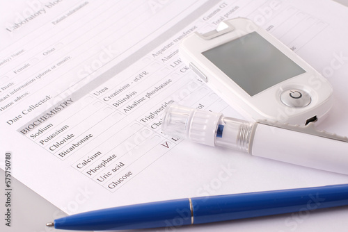 Filling in the data of the medical form with a glucometer and a lancet - a scarifier.