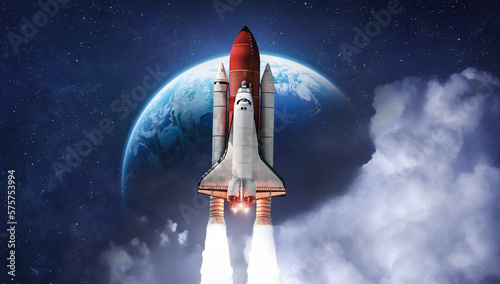 Fototapeta Naklejka Na Ścianę i Meble -  Space shuttle rocket in deep space with clouds and Earth planet. Spaceship on orbit of the planet. Sci-fi space wallpaper. Elements of this image furnished by NASA