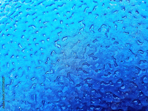 Close up of ice overlay on blue metal background