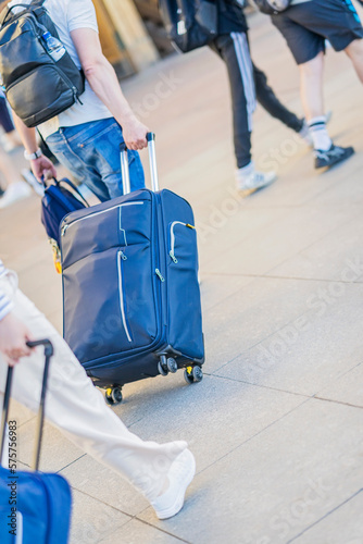 Abstract walking man with suitcase and backpacks, the concept of emigration, departure. Intentional sloping level