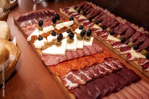 Food decoration on a wooden table. Tasty food on a table. Meat and cheese at the party event. 