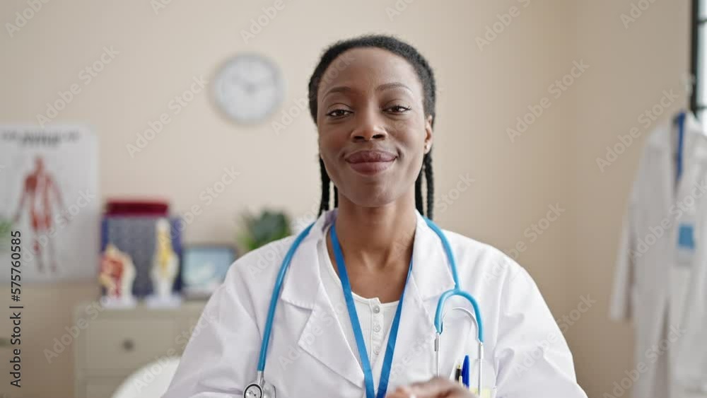 African american woman doctor smiling confident wearing medical mask at clinic African american woman doctor smiling confident wearing medical mask at clinic