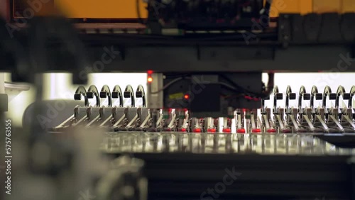 Installation of electronic components on a printed circuit board. Production of microelectronics and semiconductors by a modern robot. High-tech equipment for assembling chips at the factory.