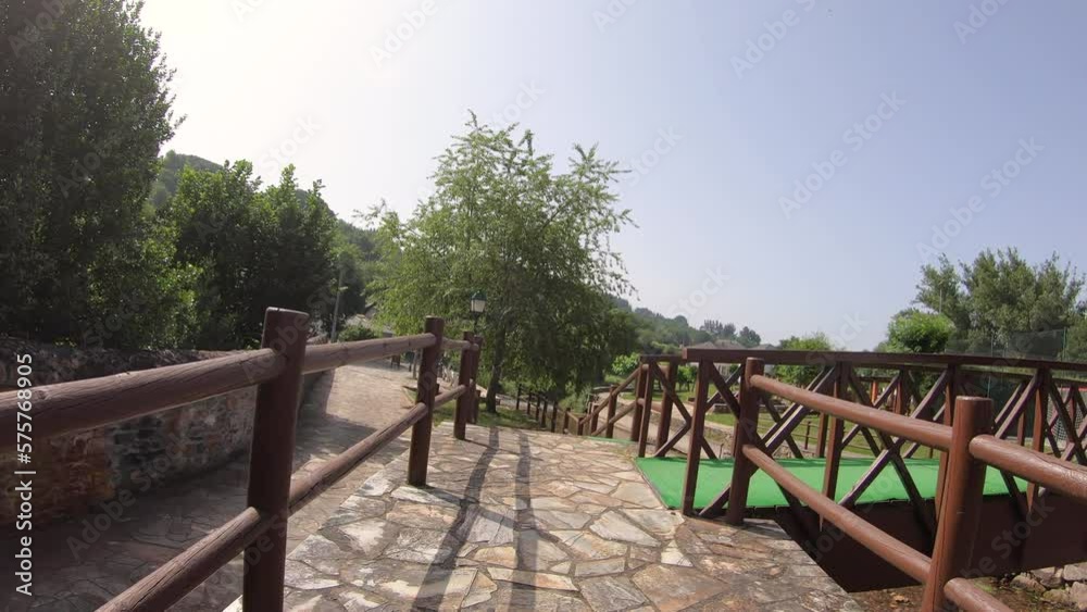 wooden bridge over Saa river in the recreational area at A Pobra do Brollón, province of Lugo, Galicia, Spain - June 2022 wooden bridge over Saa river in the recreational area at A Pobra do Brollón, province of Lugo, Galicia, Spain - June 2022