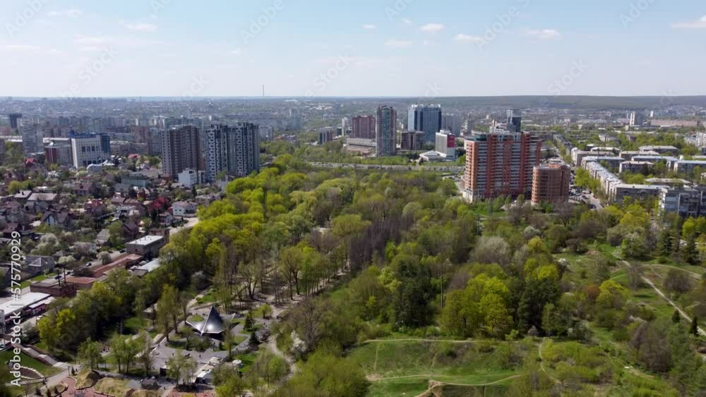 Aerial flying backwards view on green Kharkiv city and popular recreation park Sarzhyn Yar. Botanical garden in residential area in spring Aerial flying backwards view on green Kharkiv city and popular recreation park Sarzhyn Yar. Botanical garden in residential area in spring