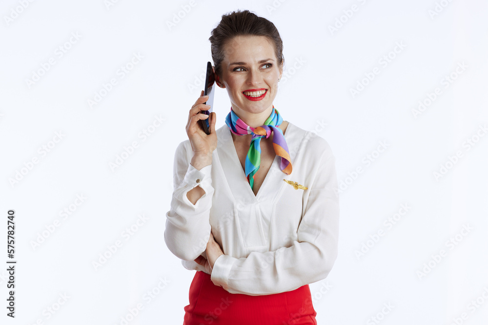 happy stylish air hostess woman on white using smartphone happy stylish air hostess woman on white using smartphone