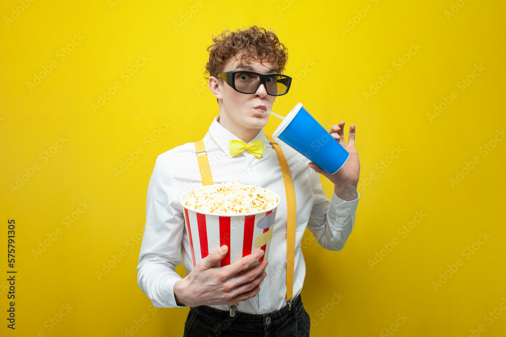 guy in festive outfit in 3d glasses watches movie with popcorn, nerd student in bow tie and suspenders cinema viewer