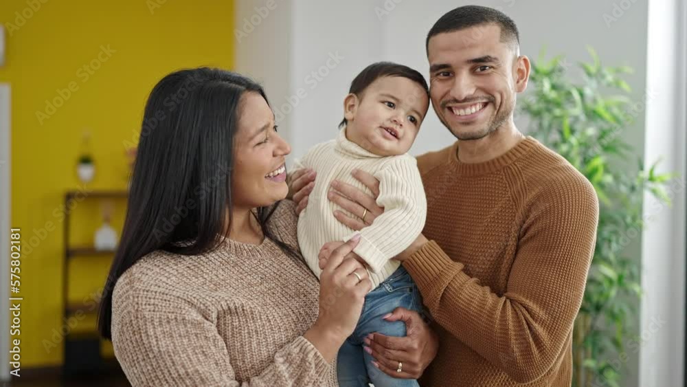 Couple and son hugging each other standing at home Couple and son hugging each other standing at home