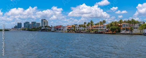 Apartments and buildings along the Biscayne Bay in Miami Beach Florida. Scenic skyline and the Intracoastal Waterway with blue sky and puffy clouds.