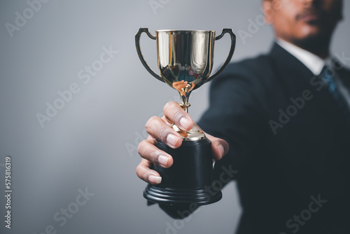 Fotografie Businessman, success, company president Holding an outstanding trophy for corpor