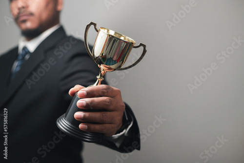 Konstfotografi Businessman, success, company president Holding an outstanding trophy for corpor