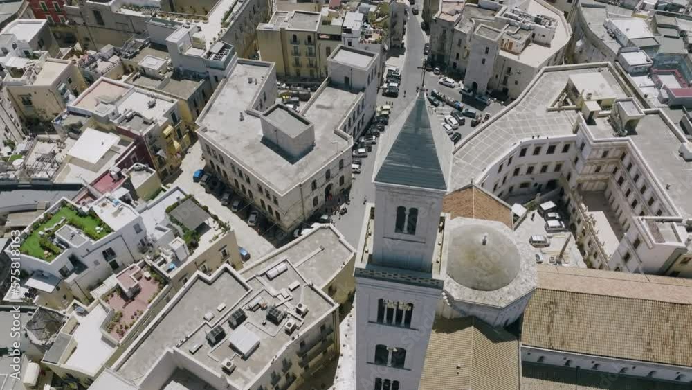 Aerial footage rotating around the cross and steeple of Basilica Cattedrale Metropolitana Primaziale San Sabino in Bari, Italy.