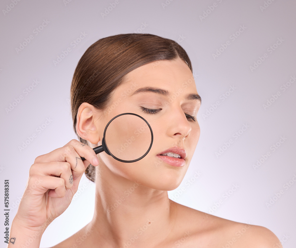 Woman, magnifying glass and face in studio for beauty, cosmetics and dermatology. Facial magnifier, female model and check skincare, aesthetic wellness and inspection for acne, laser and search pores Woman, magnifying glass and face in studio for beauty, cosmetics and dermatology. Facial magnifier, female model and check skincare, aesthetic wellness and inspection for acne, laser and search pores