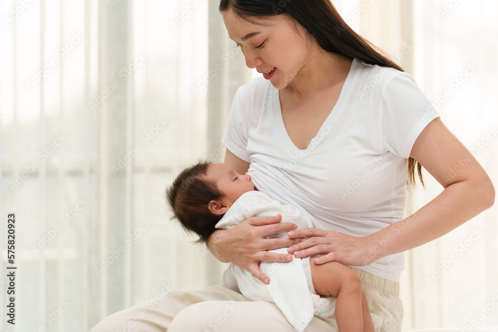 mother breastfeeding newborm baby near the window mother breastfeeding newborm baby near the window