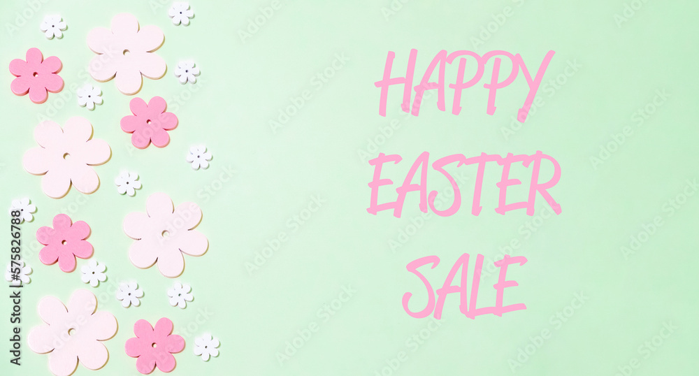 Happy easter sale text on a pink background with flowers