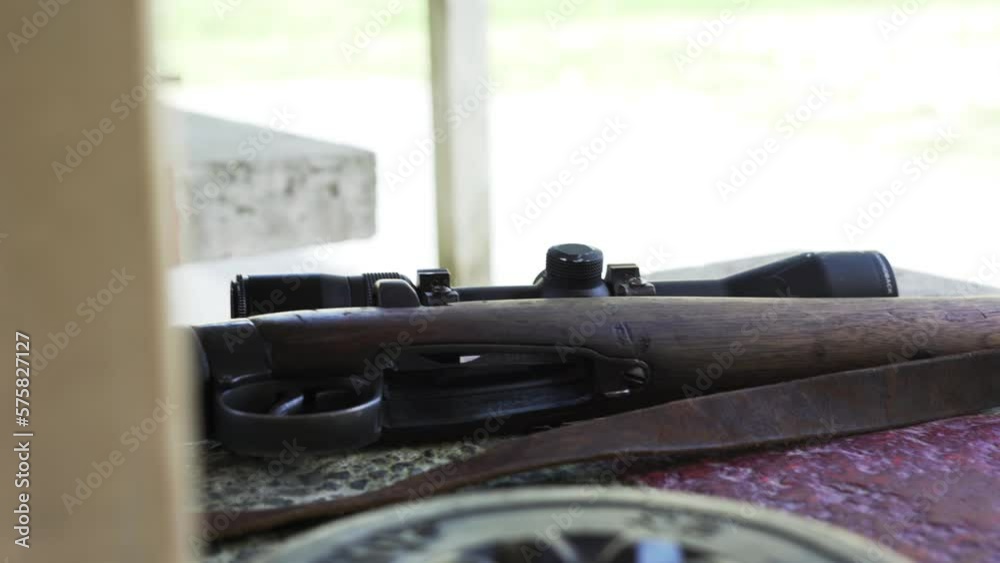 Closeup Of A Wooden Rifle On The Table At The Firing Range. handheld shot Closeup Of A Wooden Rifle On The Table At The Firing Range. handheld shot