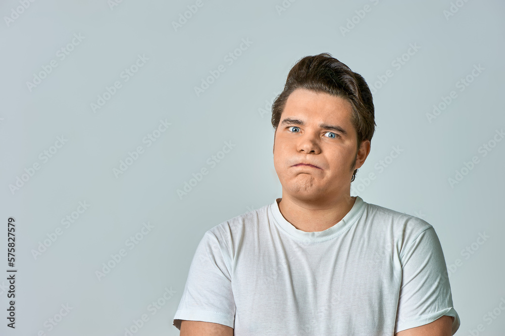 a frowning man on a gray background, copy space a frowning man on a gray background, copy space