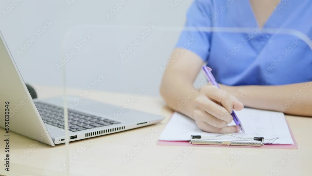 Asian female doctor working on a notebook Asian female doctor working on a notebook