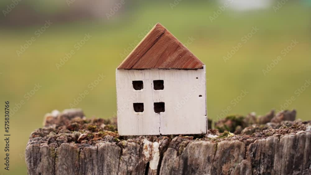 Earthquake concept. Shaking wooden house model close up Earthquake concept. Shaking wooden house model close up