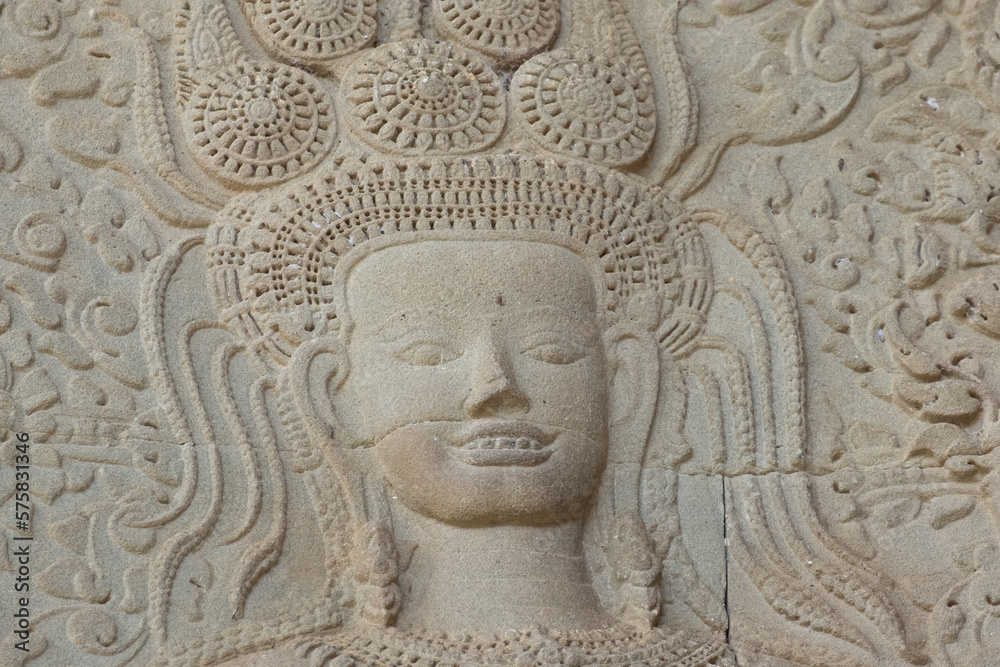 Close up of an iconic APSARA bas-relief who shows her teeth with a smile in Angkor Wat of Siem Reap, Cambodia.