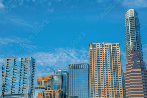 Apartments and corporate buildings under the blue sky at Austin, Texas. Cityscape views with one building under construction in the middle.