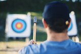 Sports, bullseye and man with axe for target on range for training, exercise and hunting competition. Extreme sport, fitness and male archer aim with tomahawk weapon for practice, games and adventure