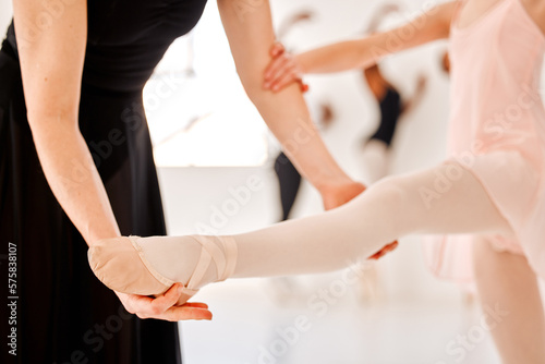 Fototapeta Naklejka Na Ścianę i Meble -  Closeup, ballet and coach with girl, support and training for flexibility, motivation and performance in classroom. Zoom, female ballerina and dancer with trainer, mentor and routine for development