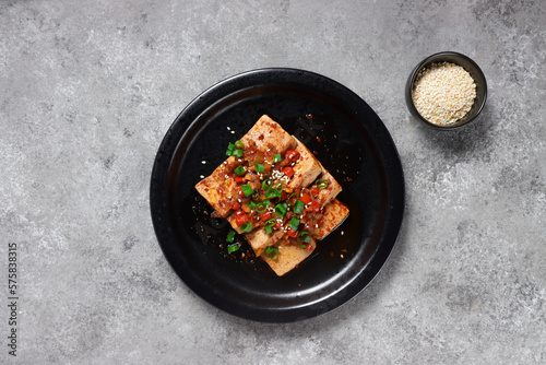 Dubu Jorim is a Korean Braised Tofu. Fried Tofu with Soy Sauce and chillies.