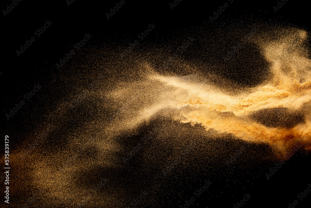 Sand explosion isolated on black background. Freeze motion of sandy dust splash.Sand texture concept. - obrazy, fototapety, plakaty 