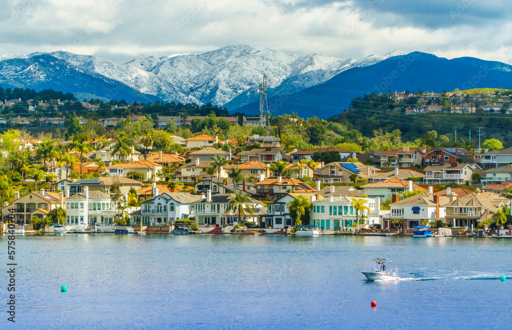 Lake Mission Viejo with snow capped Santa Ana Mountains in the distance, after epic snowstorm in Southern California