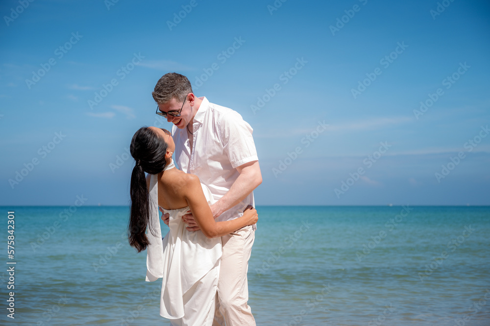 happy couple jumping on the beach romantic moments in honeymoon trip.