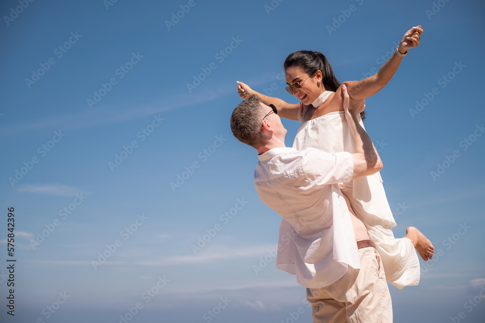 happy couple jumping on the beach romantic moments in honeymoon trip. happy couple jumping on the beach romantic moments in honeymoon trip.