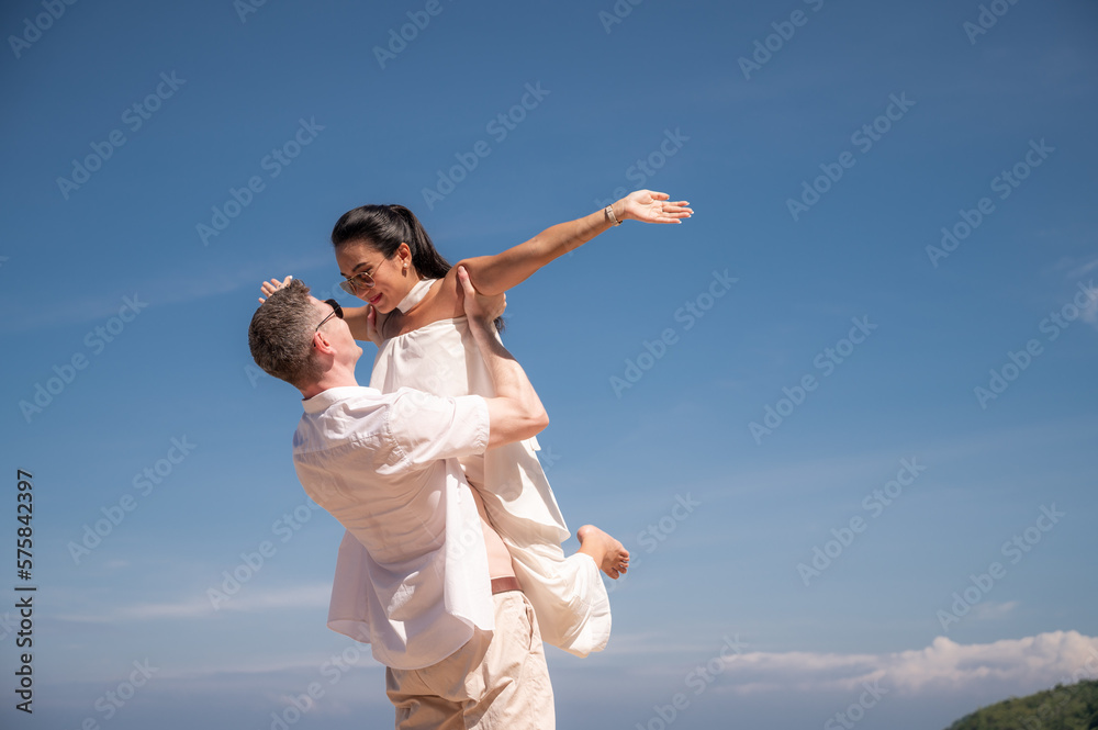 happy couple jumping on the beach romantic moments in honeymoon trip. happy couple jumping on the beach romantic moments in honeymoon trip.