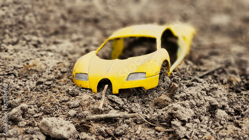 toy car on the sand
yellow car
broken car
car wrecked