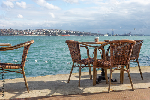 Chairs and tables in a street cafe on the pier. © Sergey Lorgus