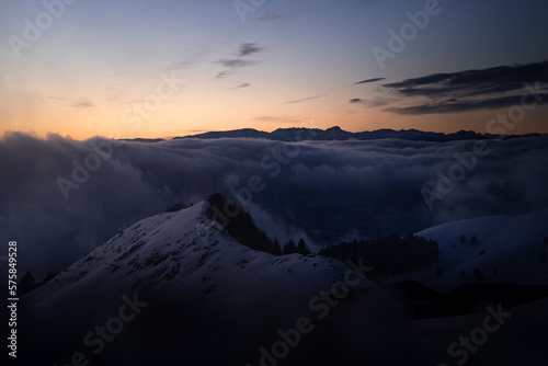 sunset over a sea of clouds in winter photo