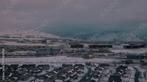 Commuter train in a winter, suburban community - sliding aerial view photo