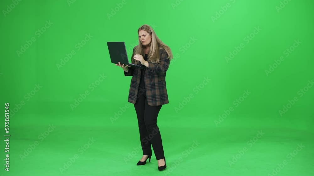 Woman typing and uses laptop on the go, manager on a green background, makes purchases online, chromakey template. Woman typing and uses laptop on the go, manager on a green background, makes purchases online, chromakey template.