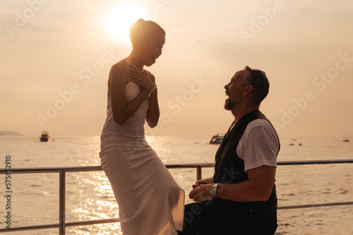 The moment of a marriage proposal on a yacht.
