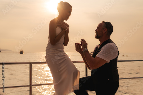 The moment of a marriage proposal on a yacht.