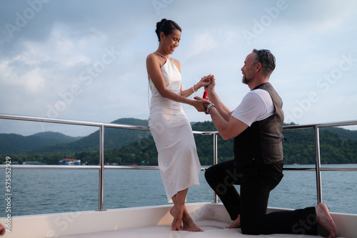 The moment of a marriage proposal on a yacht.