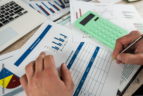 businessman working with annual financial statistics documents with diaram and chart and calculator