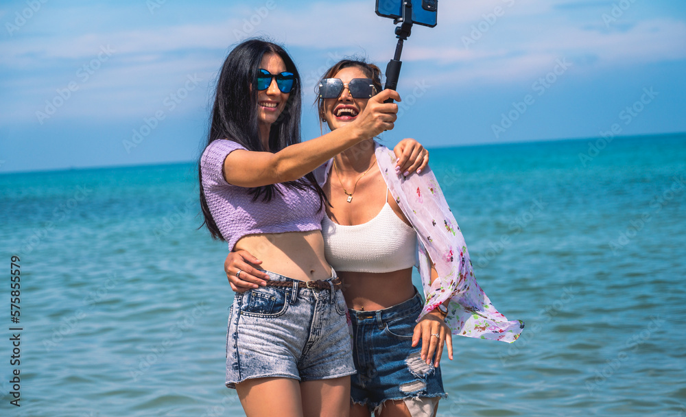 Lifestyle women and friends having fun and enjoying being themselves.Girls smiling and selfie with friends by the sea on the tropical island.Concept summer travel. Lifestyle women and friends having fun and enjoying being themselves.Girls smiling and selfie with friends by the sea on the tropical island.Concept summer travel.