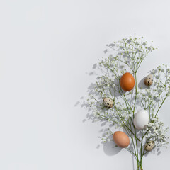 Elegant minimalist Easter greeting card design, natural color eggs and flowers on neutral light background, copy space
