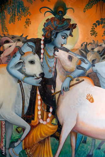 Painting depicting Hindu god Krishna hugging cows. India.