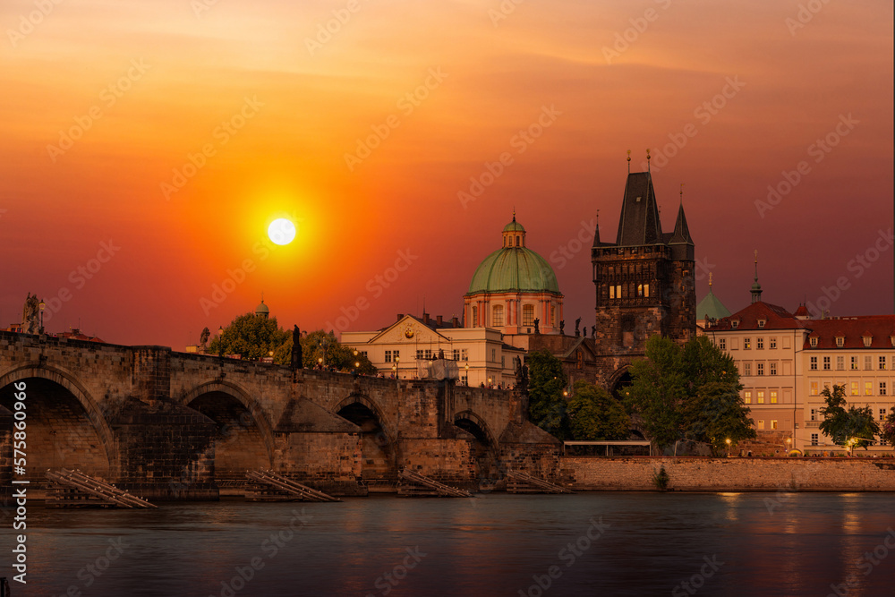Prague with Old Town Bridge Tower and Charles bridge over Vltava river at sunset, Czechia