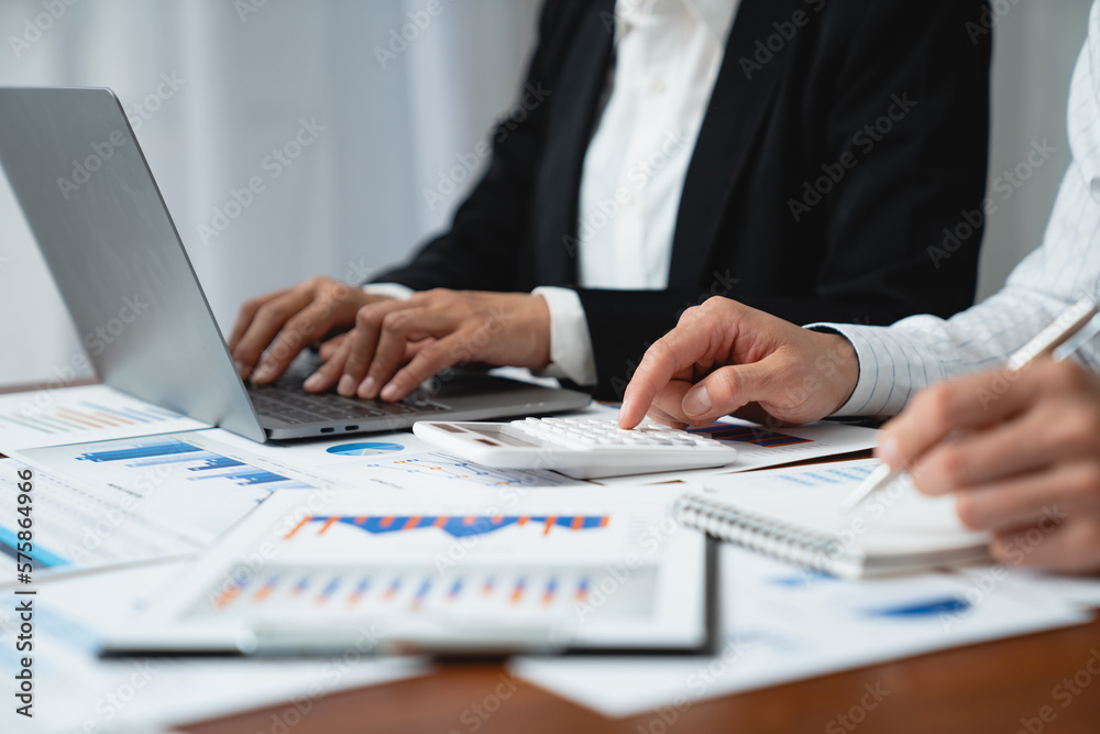 Asian businessmen discuss graphs and chart data analysis and use calculators to calculate numbers. business finance and accounting concepts. Asian businessmen discuss graphs and chart data analysis and use calculators to calculate numbers. business finance and accounting concepts.