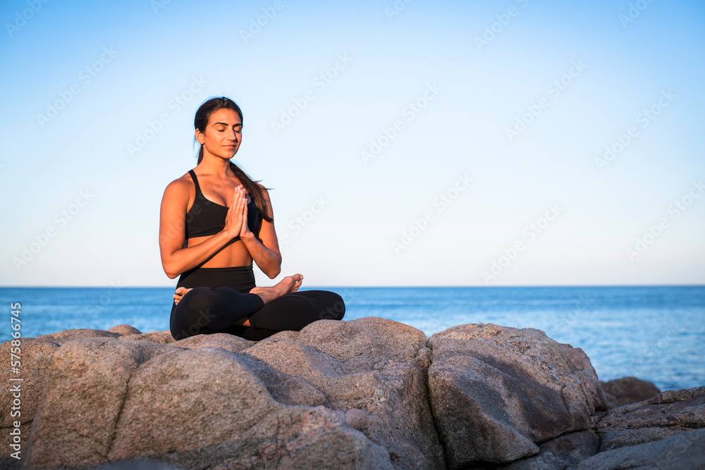 Woman doing yoga on seashore, Narragansett, Rhode Island, USA Woman doing yoga on seashore, Narragansett, Rhode Island, USA