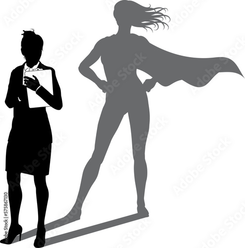 A superhero business woman revealed by her shadow silhouette as a super hero in a cape